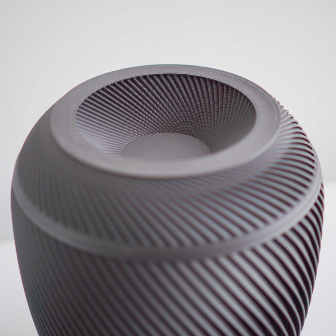 Close-up of the black Elm cremation urn showing its modern sculpted texture and matte finish lid detail shot.
